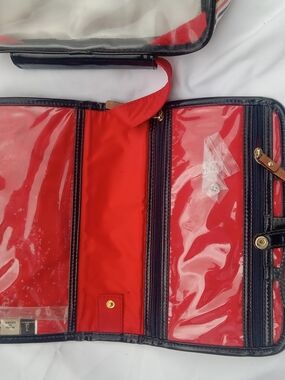 Kate Spade travel cosmetic train case featuring a striped PVC exterior and a top